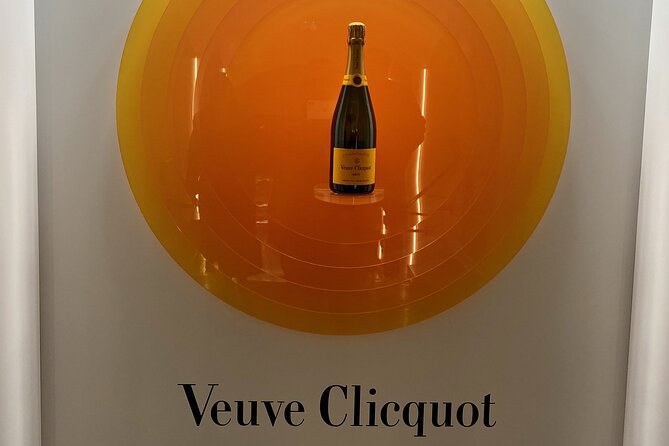 A single bottle displayed in a yellow disc above the name Veuve Clicquot