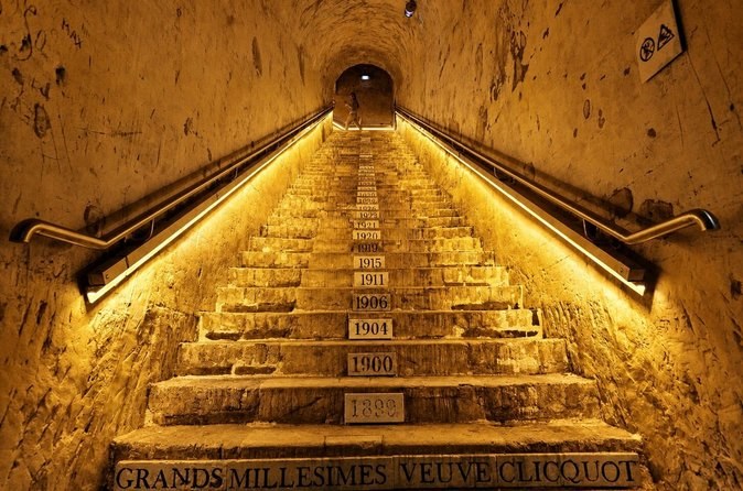 Chalk steps down into the cellars, each marked with a vintage year, above the words Grands Millésimes Veuve Clicquot