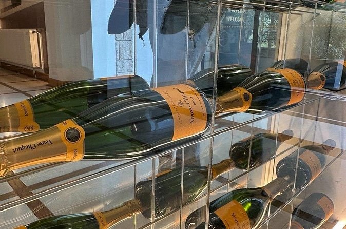 Yellow Label bottles lying on a glass rack by a window